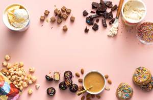 Various cake-flavored foods shot from above on a pink background